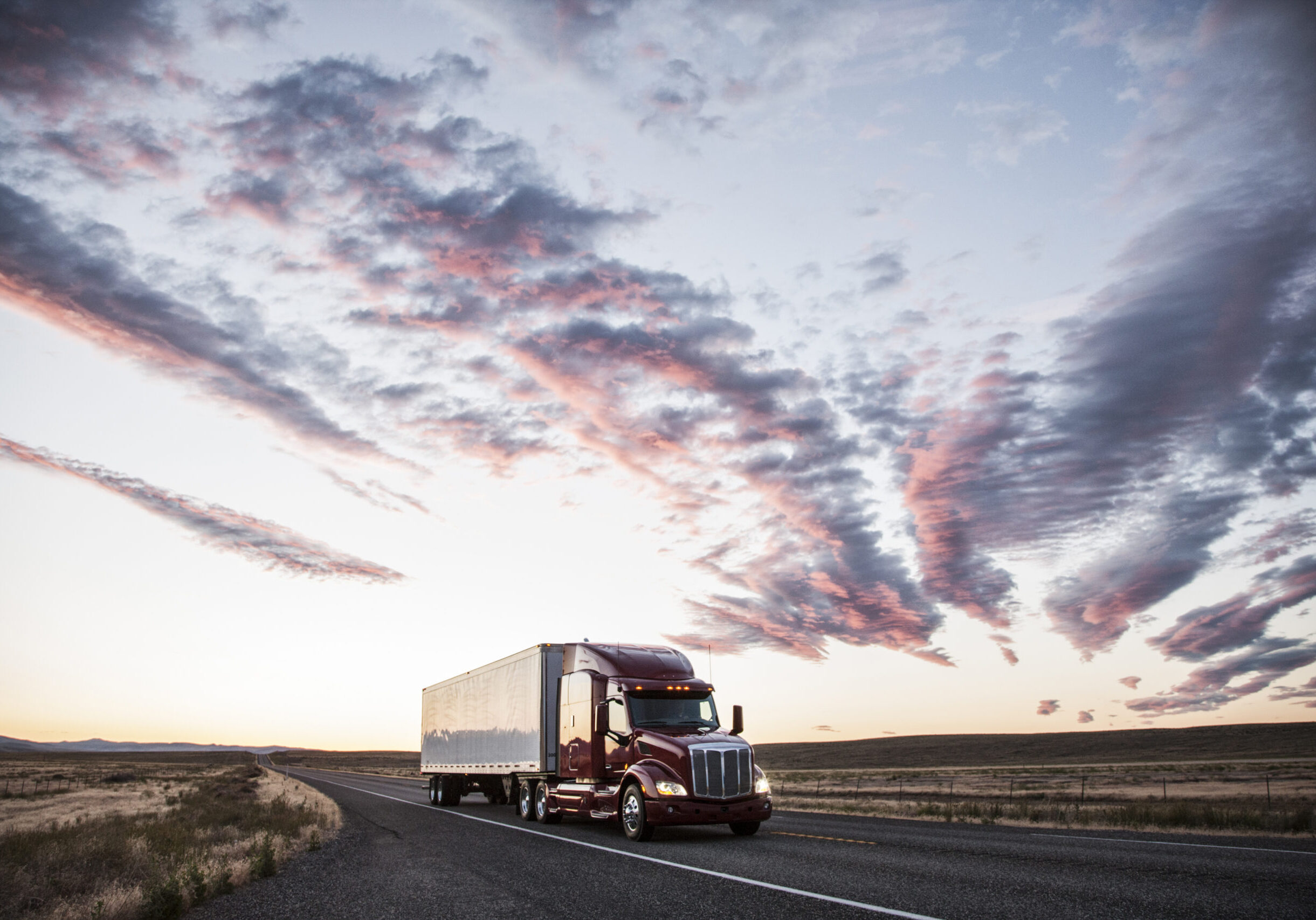 3/4 front view of a  commercial truck on the road at sunset  in eastern Washington, USA