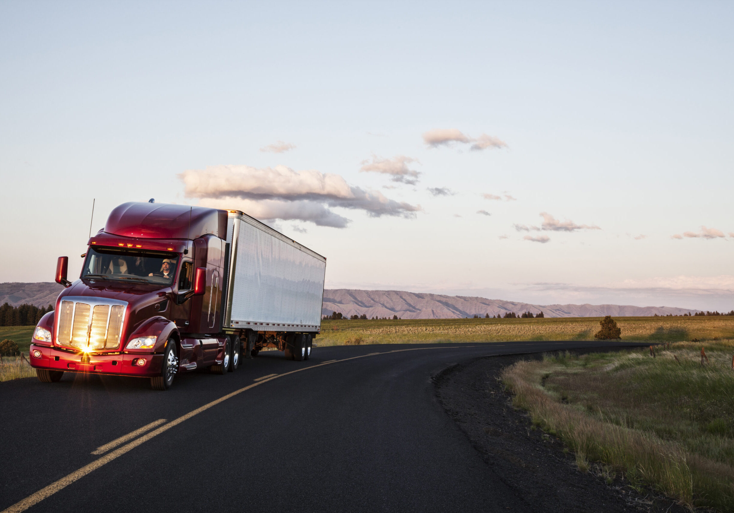truck on a highway through the grasslands area of eastern Washington, USA.
