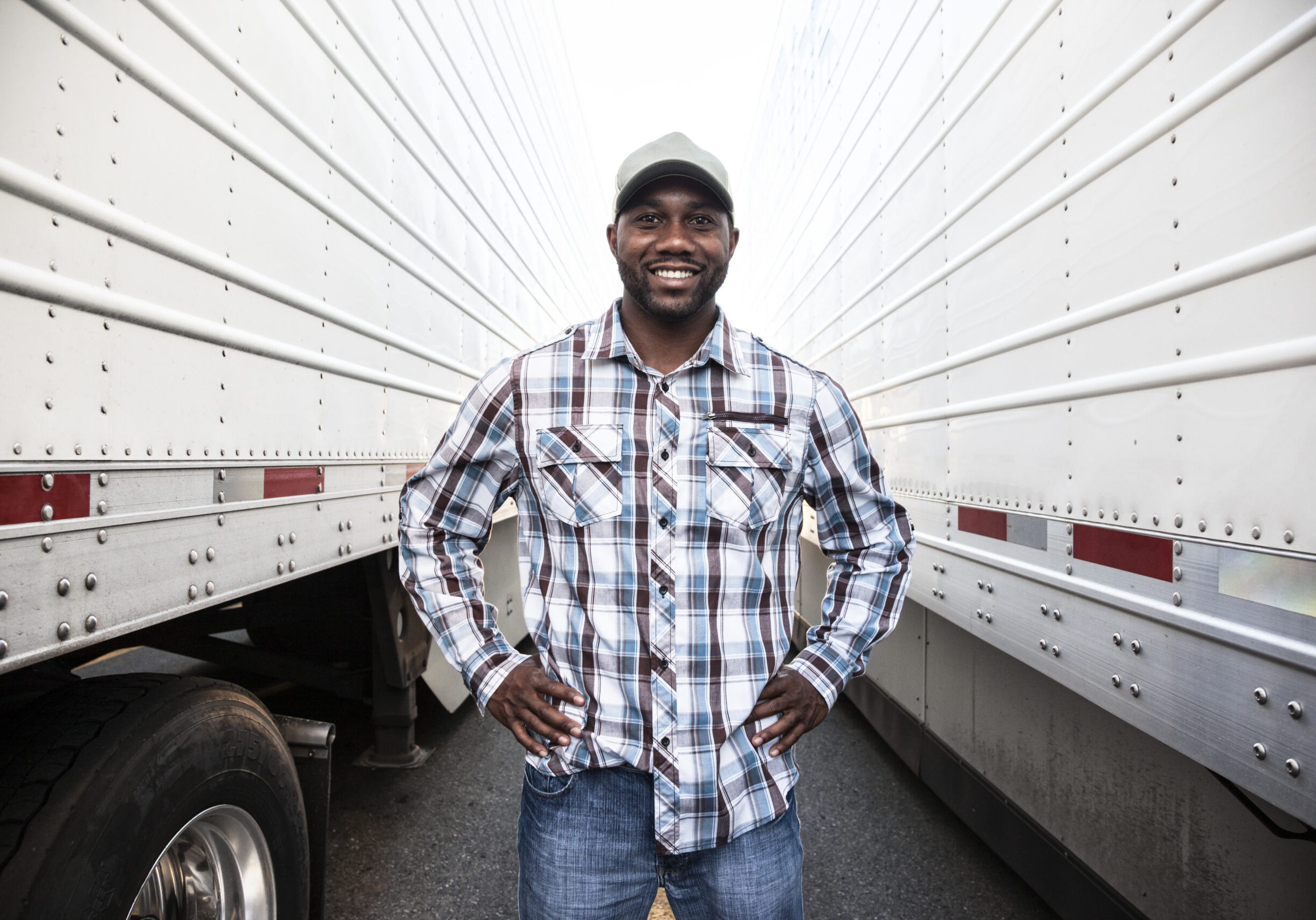 Trucker standing by his large truck
